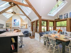 a kitchen and living room with a table and chairs at Bailey Cottage in Southampton