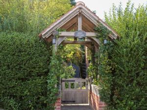 a wooden gate with ivy growing around it at Bailey Cottage in Southampton