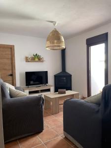 a living room with two couches and a fire place at La Casa del Muro in El Bosque