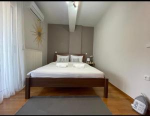 a bedroom with a bed with two towels on it at Penthouse with great Lake view in Ioannina