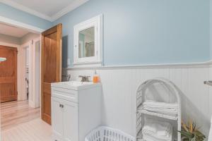 a white bathroom with a sink and a mirror at Large Patio with Ocean Views Beach Block Parking Unit 3 in Ventnor City