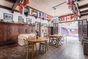 a room with tables and chairs and flags on the wall at Pura Vida Hostel in Rio de Janeiro