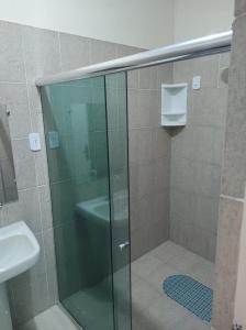 a glass shower in a bathroom with a sink at Pousada Maria Bonita - Piranhas, Alagoas. in Piranhas +31 photos
