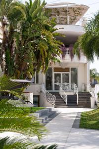 a house with palm trees in front of it at Hotel Imperiale in Terzigno