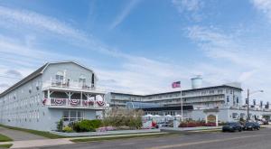 a large white building with an american flag in front of it at Grand Hotel Cape May in Cape May