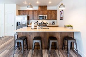 a kitchen with a large counter with stools at it at Tamarack Trails Bungalow in Donnelly
