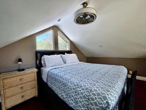una camera da letto con un letto con un piumone blu e una finestra di Cheerful one bedroom loft cabin close to wineries a Fair Play