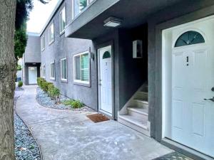 a building with a white door and a sidewalk at Quiet Remodeled 3 Bedroom in Heart of Downtown Sacramento in Sacramento