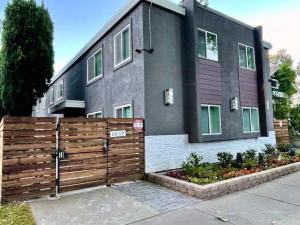 a house with a wooden fence in front of it at Quiet Remodeled 3 Bedroom in Heart of Downtown Sacramento in Sacramento