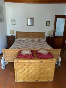 a bed in a bedroom with a large bed at La Casa dei Nonni in Castagneto Carducci