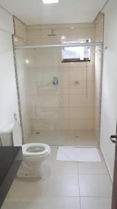 a bathroom with a shower and a toilet at Premium Palace Hotel in Ariquemes