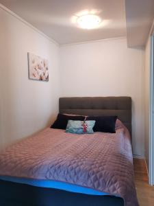 a bedroom with a bed with a purple comforter at The House of Aurora I in Tromsø