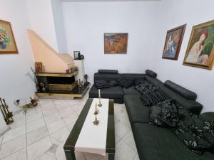 a living room with a couch and a coffee table at Tsar Simeon, 2 bedroom, living room and fireplace in Sofia