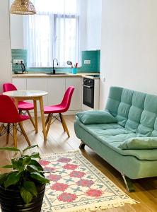 a living room with a blue couch and a table at Old batumi in Batumi