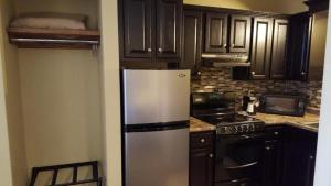 a kitchen with a white refrigerator and a stove at Jackson Town House Inn in Jackson