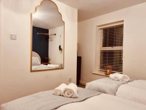 2 łóżka w pokoju z lustrem w obiekcie 'Afton' at stayBOOM w mieście Lancaster