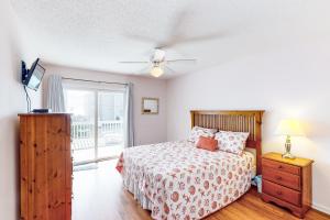 Un dormitorio con una cama y una cómoda y una ventana. en My Get Away, en Surf City