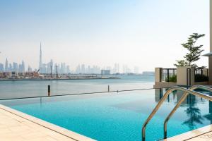 a swimming pool with a view of the city at Ultimate Stay / 4 People / Beachfront / Sea View / Balcony Sunset / Brand New / La Mer in Dubai