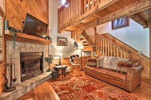 a living room with a couch and a fireplace at CREEKSIDE Tiny Cabin by Pigeon Forge in Sevierville