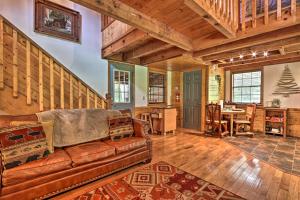 a living room with a couch and a table at CREEKSIDE Tiny Cabin by Pigeon Forge in Sevierville