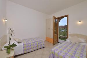 A bed or beds in a room at Residence Le Zagare