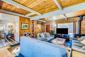 a living room with a couch and a tv at Foxglove Terrace in South Lake Tahoe