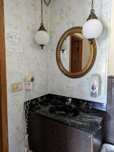 a bathroom with a sink and a mirror at Crossroads motel & cabins in Oxford