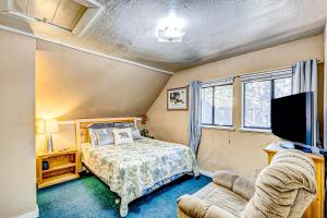 a bedroom with a bed and a tv and a couch at Foxglove Terrace in South Lake Tahoe