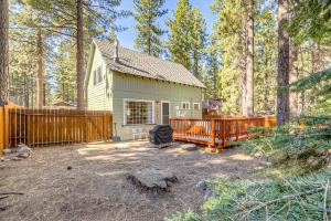a house in the woods with a wooden fence at Foxglove Terrace in South Lake Tahoe