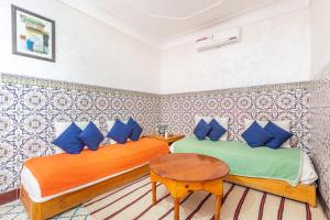 מיטה או מיטות בחדר ב-Exclusive private Riad