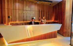 a man and a woman standing in a lobby at Woodside Residences Ski&Spa in Kopaonik