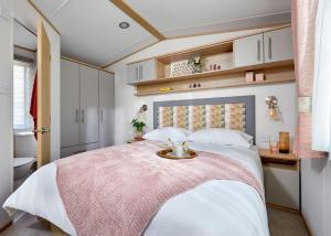 - une chambre avec un lit et un plateau dans l'établissement Willows Holiday Park, à Withernsea