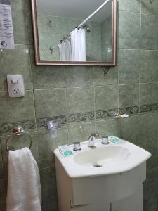 a bathroom with a white sink and a mirror at Ruca Nel in El Calafate