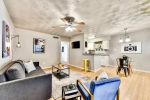 a living room with a couch and a ceiling fan at Global Cup Dallas Boutique Flat - Arboretum Tickets Included in Dallas