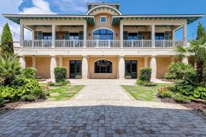 a large house with a balcony on top of it at Cinzia Lane Bungalow in Myrtle Beach