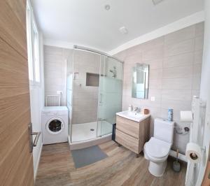 a bathroom with a shower toilet and a sink at Fortel Clairmarais in Reims