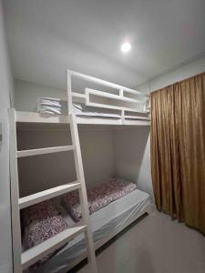 a white bunk bed in a room at ChaVid town house has two bedrooms in San Fernando