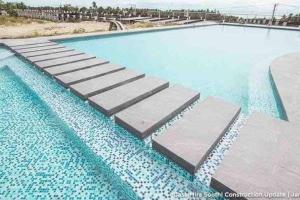 a swimming pool with steps in the water at ChaVid town house has two bedrooms in San Fernando