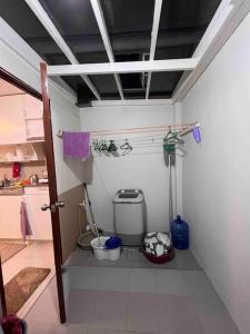 a small bathroom with a toilet in a room at ChaVid town house has two bedrooms in San Fernando