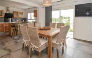 a kitchen and dining room with a wooden table and chairs at Beautiful Home In Agde in Le Grau-dʼAgde