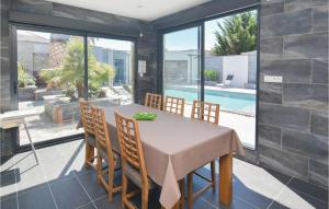 a dining room with a table and chairs and a pool at Beautiful Home In Agde in Le Grau-dʼAgde
