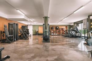 a fitness room with a gym with exercise equipment at BFRESH Hotel - Padel, Pool & Fitness - Adults Only in Porto