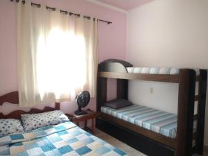 a bedroom with two bunk beds and a window at Casa de temporada in São João Batista do Glória +26 photos