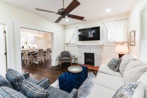 a living room with a couch and a fireplace at Adorable home near the University of Alabama in Tuscaloosa