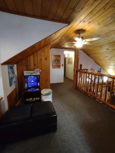 a living room with a video game in a house at Union Bay Log Home in Union Bay