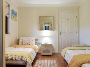 Postel nebo postele na pokoji v ubytování Sycamore Lodge