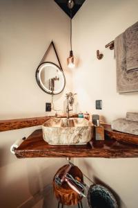 a bathroom with a sink and a mirror at Cabana Secreta in Petrópolis