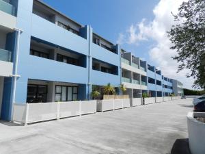 an empty parking lot in front of a blue building at Cool Apartment, Central To Everything, share with 2x Bulldogs in Auckland