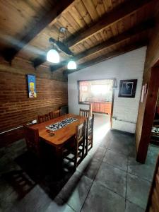 a dining room with a wooden table and chairs at Cabaña La Nena in Santa Rosa