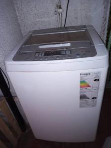 a microwave sitting on top of a white refrigerator at Hermosa casa de vacaciones en Mendoza in Guaymallen +7 photos